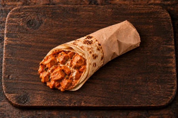 Butter chicken salomie filled with creamy house butter chicken in soft roti